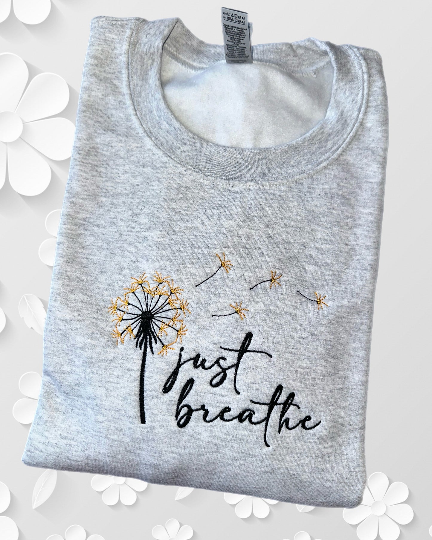 Consider a crewneck with embroidery that inspires you to 'Just Breathe' and supports mental health awareness.