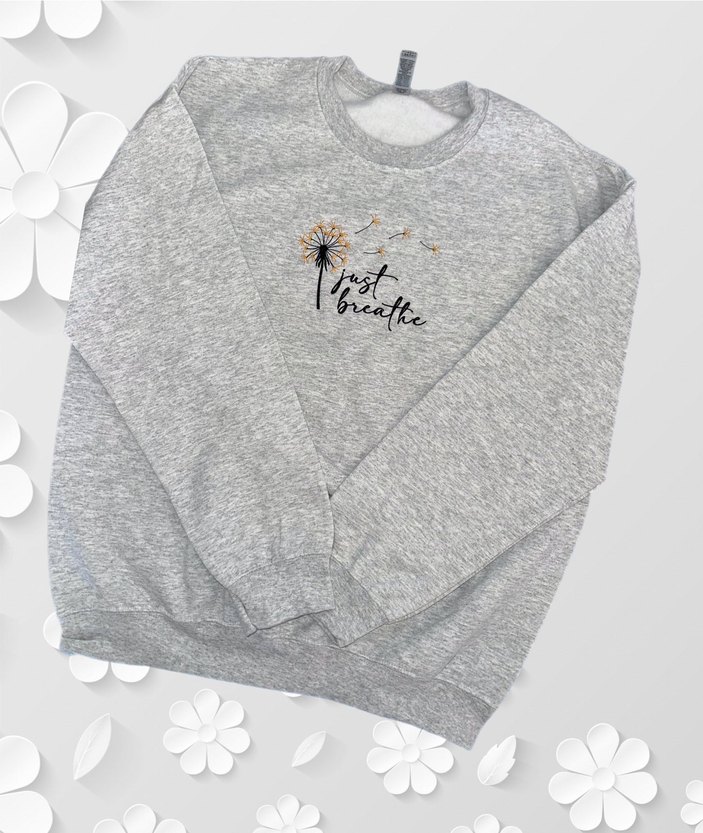 Consider a crewneck with embroidery that inspires you to 'Just Breathe' and supports mental health awareness.